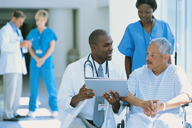 Patient in wheelchair with doctors