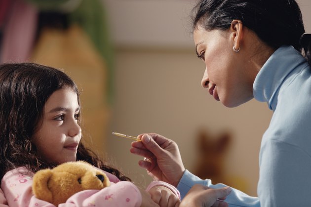 Mother taking daughter's temperature