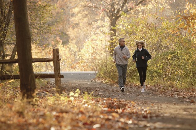 Couple jogging on scenic autumn path
