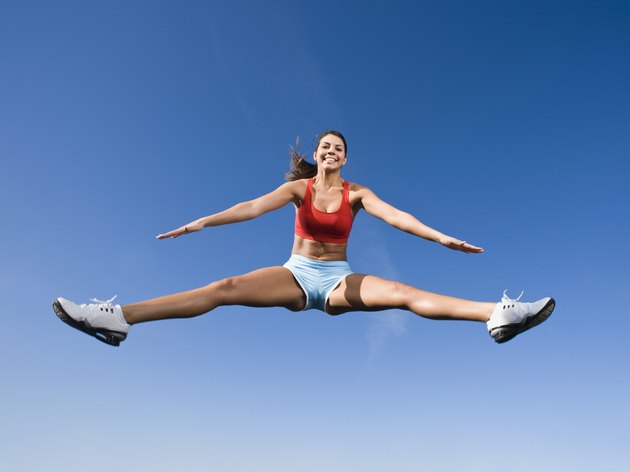 Native American woman jumping in mid-air