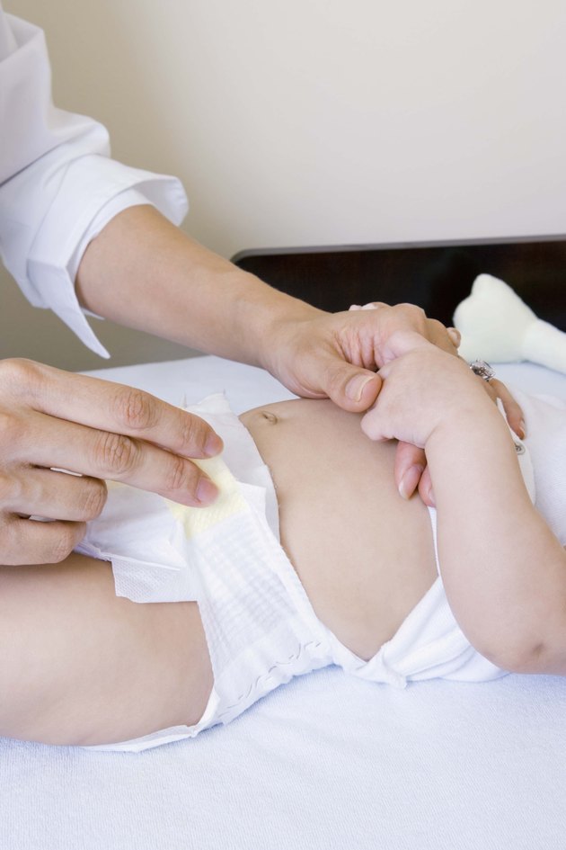 Mother with baby on changing table