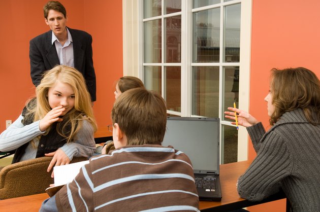 Teenagers whispering and disrupting class