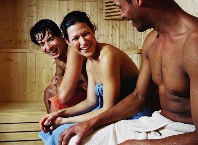 group of young people sitting in sauna smiling