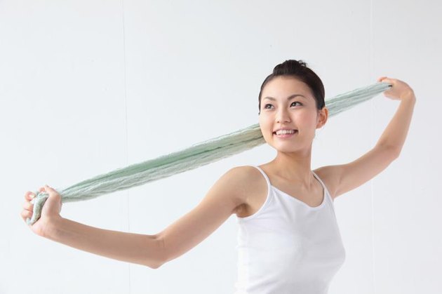 Woman stretching with a towel