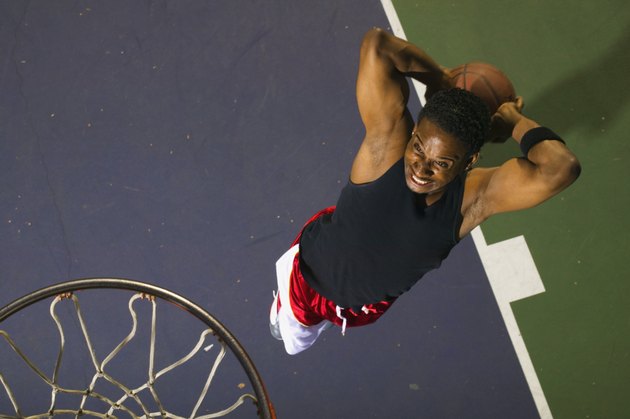 Basketball player slam dunking