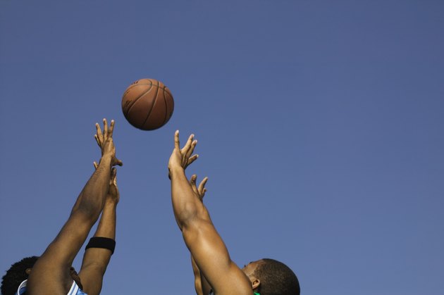 Basketball players competing for the ball
