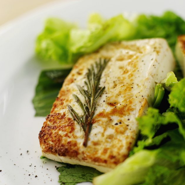 close-up of a piece of grilled cheese served on lettuce greens
