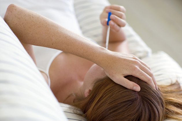 Woman taking temperature