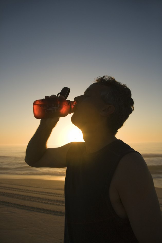 Man drinking water at beach