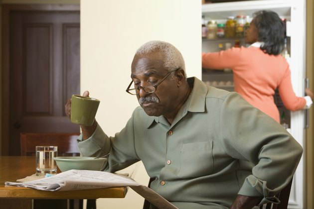 Senior African man reading newspaper