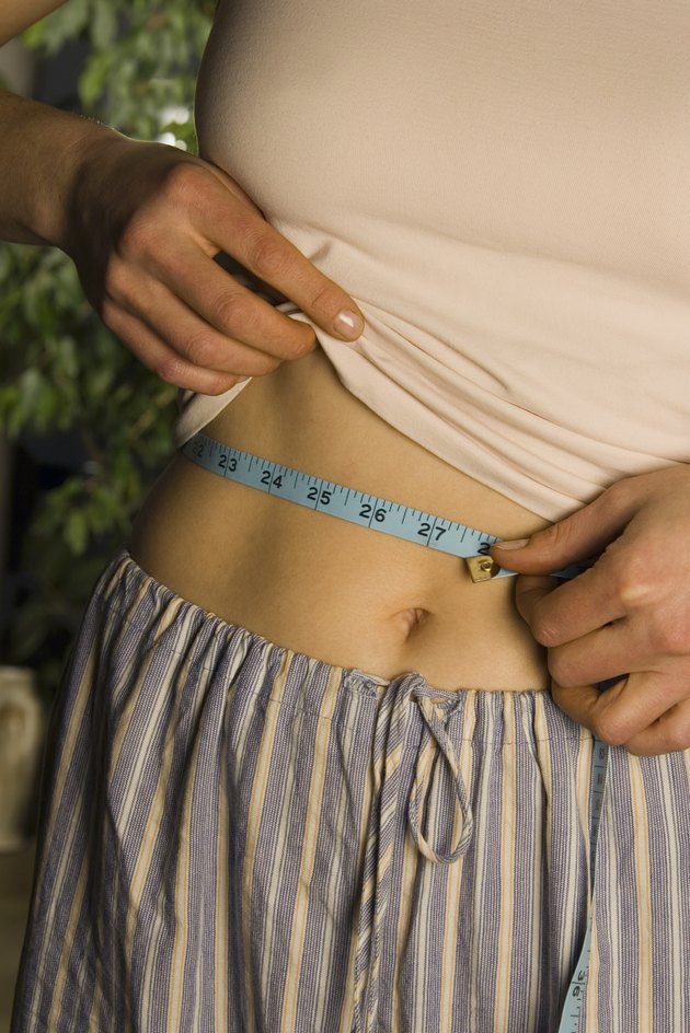 Woman measuring waist