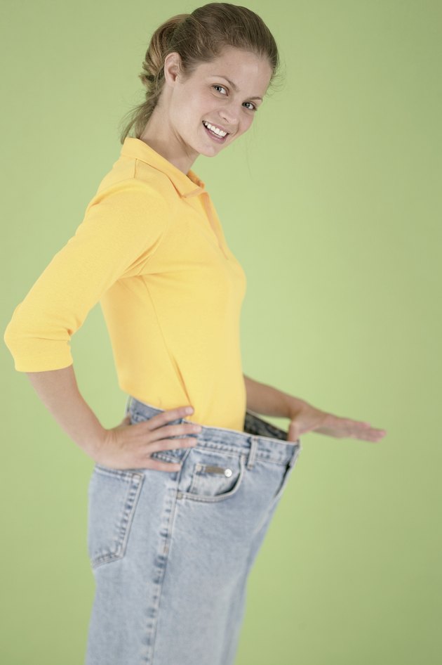 Woman wearing pants that are too big for her