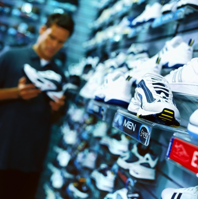 portrait of a young man looking at shoes in a shoe store