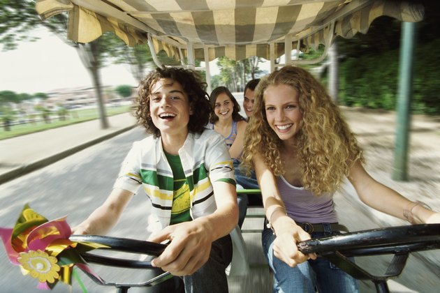 Teenage Boys and Girls Cycling With Their Friends in a Rickshaw