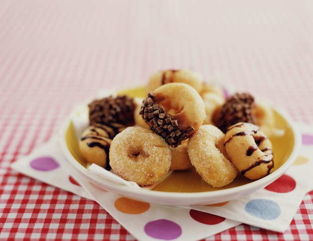 Assortment of doughnuts on plate, close-up