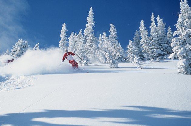 Lone skier riding through powder, British Columbia, Canada