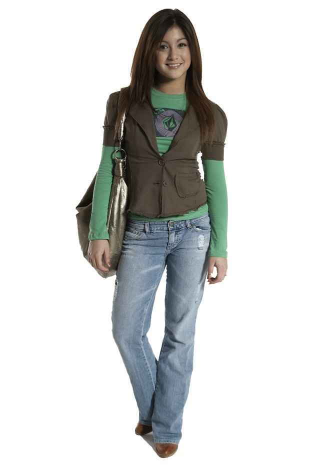 Teenage girl (15-17) carrying purse, smiling, portrait