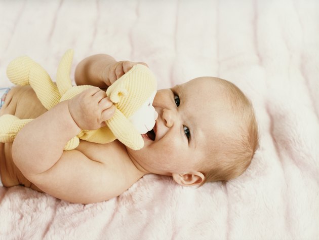 Portrait of a Baby Lying on a Bed