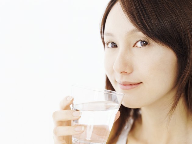 Woman Holding a Glass of Water