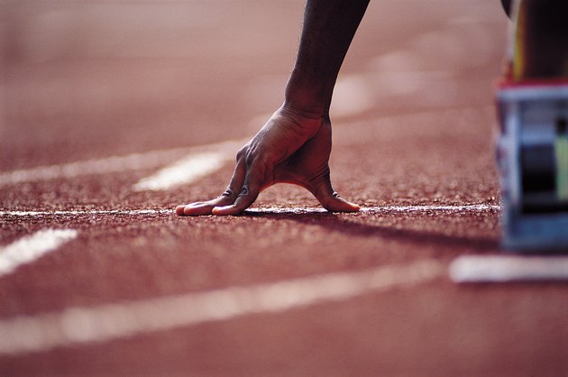 Hand of runner at starting blocks