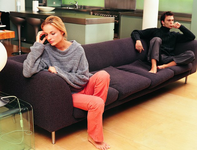 Upset Couple Sitting on a Sofa