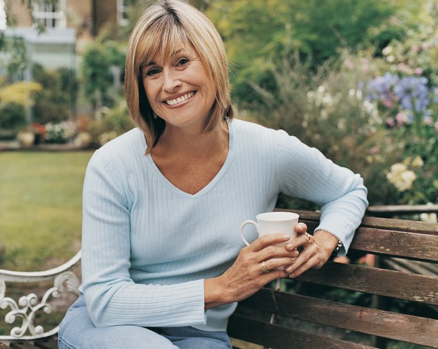 Portrait of a Middle-aged Woman Sitting in Her Garden