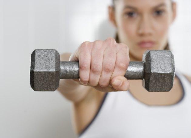 Young woman holding a dumbbell