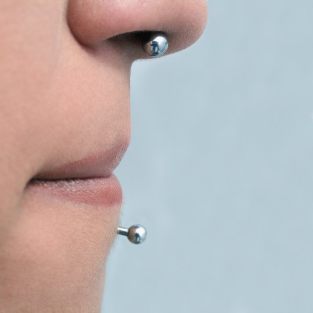 Person with nose stud and lip stud, extreme close-up
