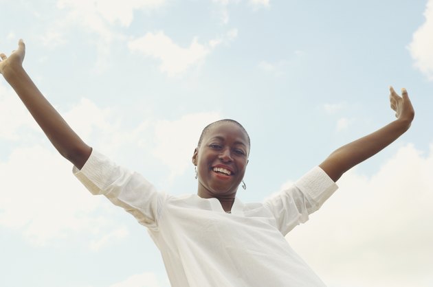 African American woman with arms raised