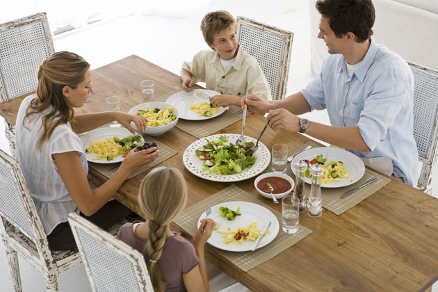 High angle view of family eating dinner together