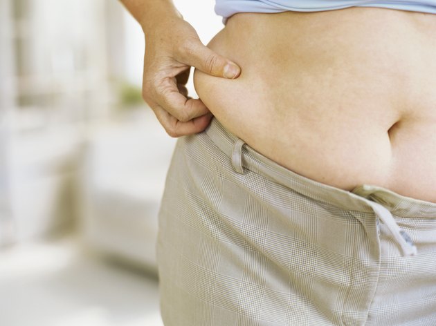 mid section view of a woman holding her belly