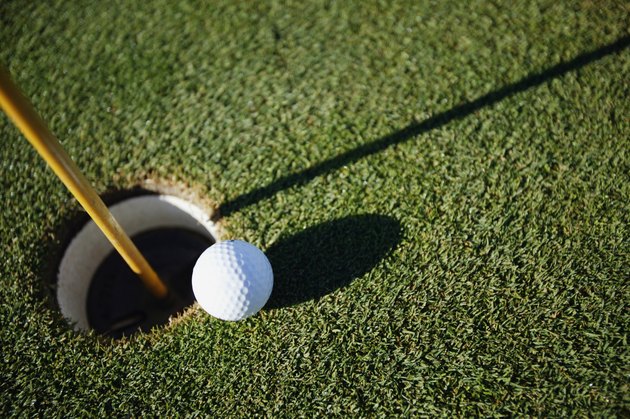 Golf ball close to pin