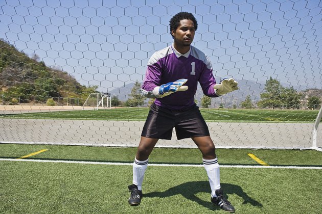 Soccer goalkeeper ready at goal
