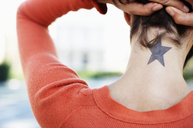 Woman Showing Her Star Tattoo