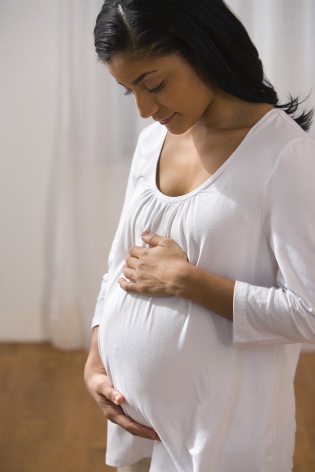 Woman holding pregnant belly
