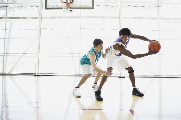Opposing basketball players on court