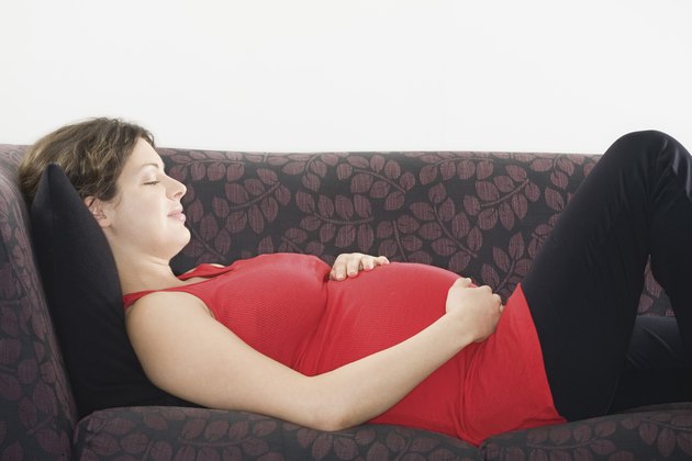 Pregnant woman sleeping on sofa