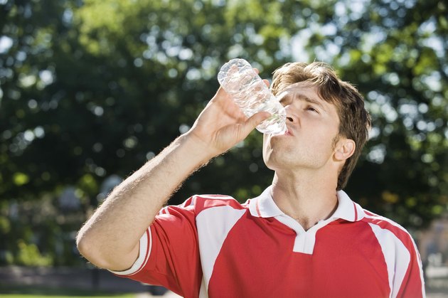 Soccer player drinking bottled water