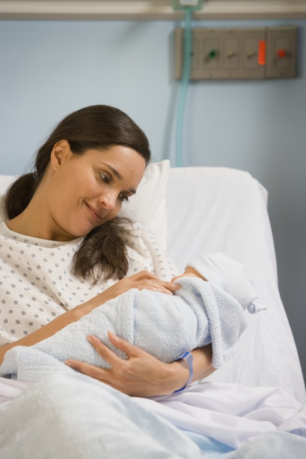 Hispanic woman in hospital with newborn baby