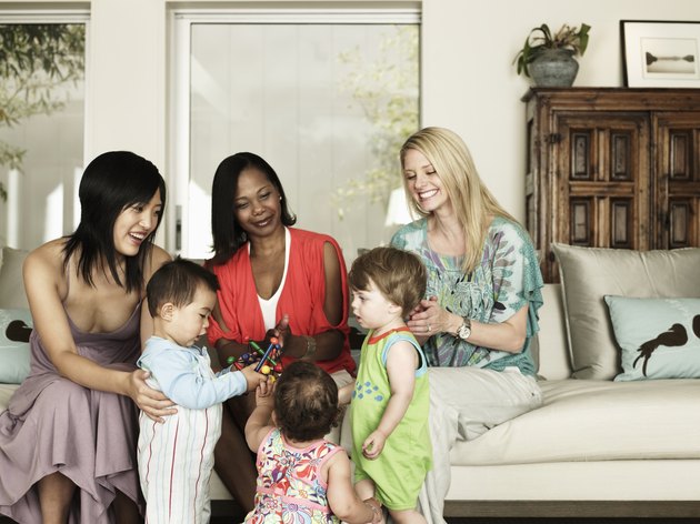 Three mothers and their children playing together