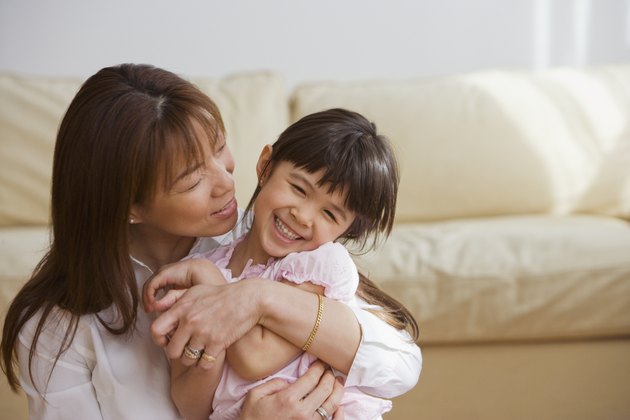 Asian mother and daughter hugging