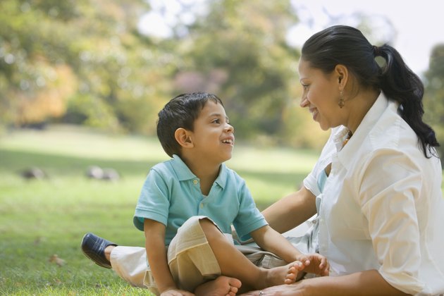 Hispanic mother and son smiling at each other