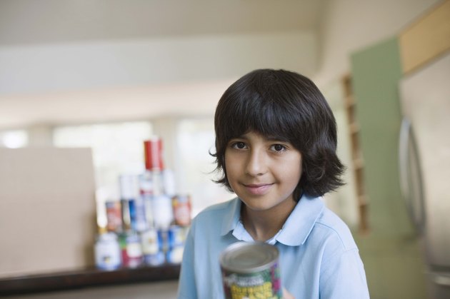 Boy holding canned food for food drive