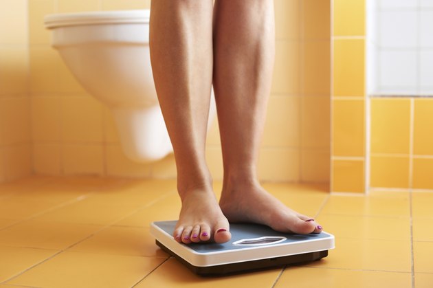 Pair of female feet on a bathroom scale