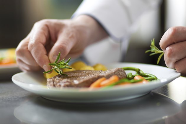 Chef garnishing a dish