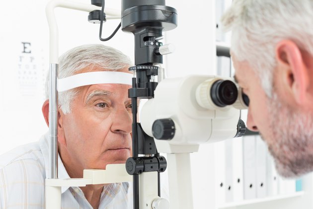 Optometrist doing sight testing for senior patient