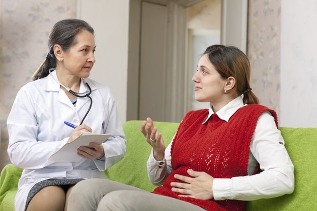 Woman complaining to doctor about stomachache