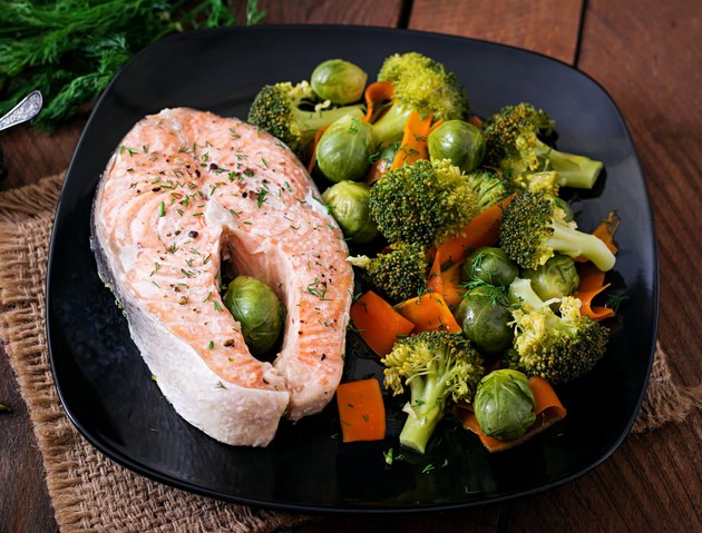 Cooked on steam salmon steak with vegetables.