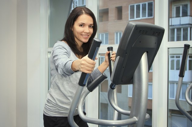 young woman doing exercise on a elliptical trainer