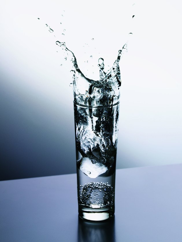 Ice Cube Splashing Into a Glass of Water